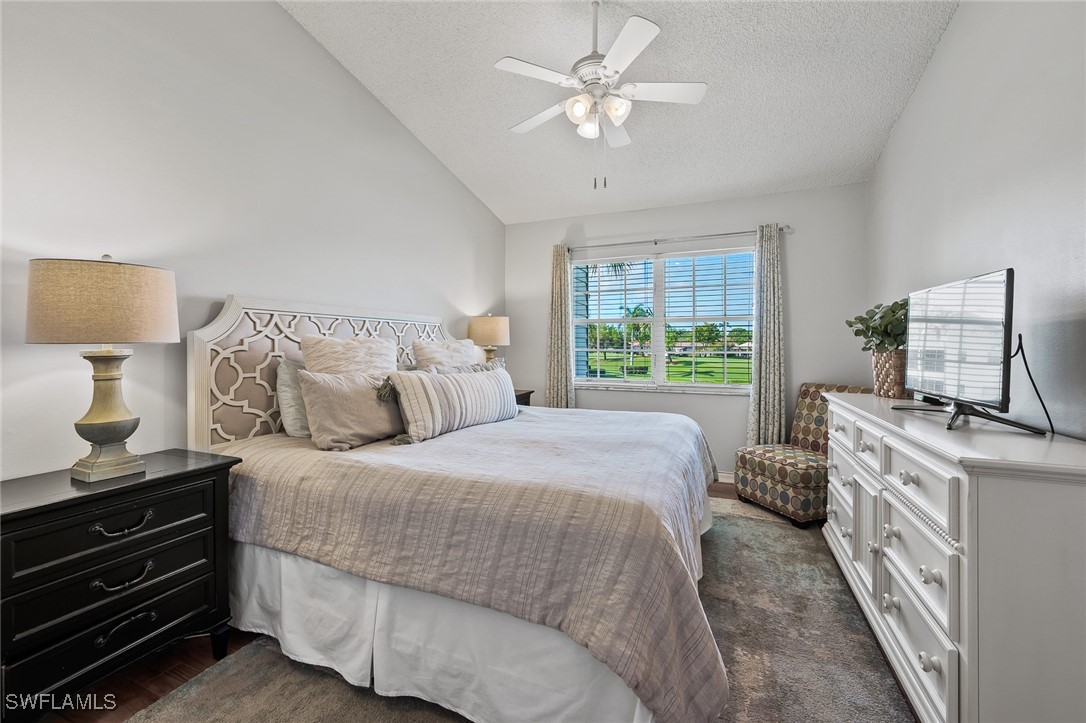 14979 Rivers Edge Court, Unit 223 Fort Myers, FL 33908 - Photo 11 of 18 a bedroom with a bed and a chandelier