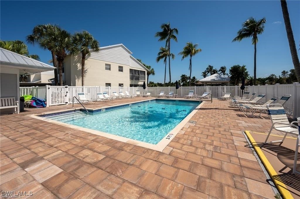 14979 Rivers Edge Court, Unit 223 Fort Myers, FL 33908 - Photo 18 of 18 a view of a backyard with a patio and swimming pool