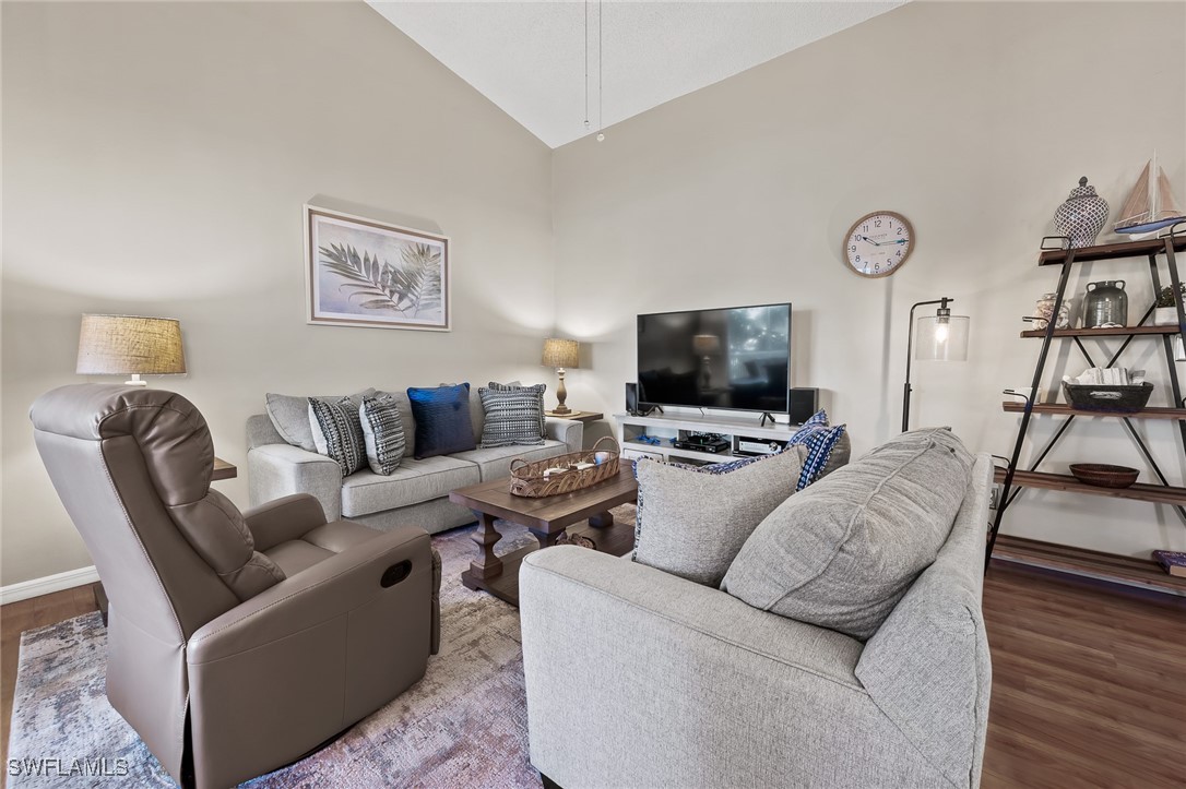 14979 Rivers Edge Court, Unit 223 Fort Myers, FL 33908 - Photo 4 of 18 a living room with furniture and a flat screen tv