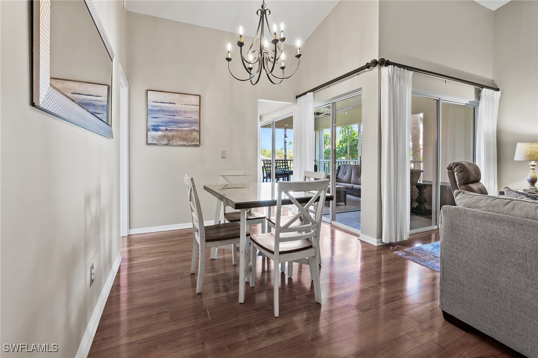 14979 Rivers Edge Court, Unit 223 Fort Myers, FL 33908 - Photo 6 of 18 a view of a dining room with furniture window and wooden floor