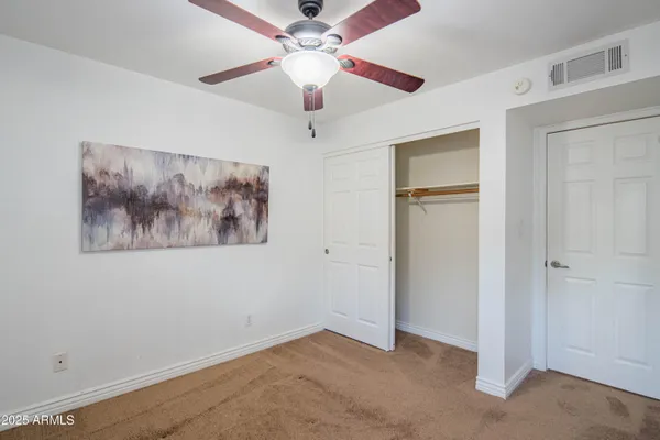 a view of a backyard with a small cabin and a chair