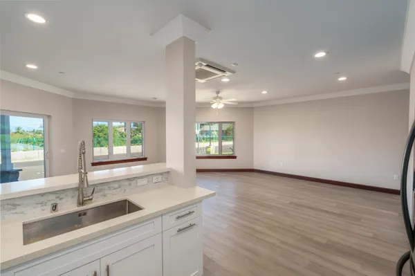 a kitchen with a sink and large window