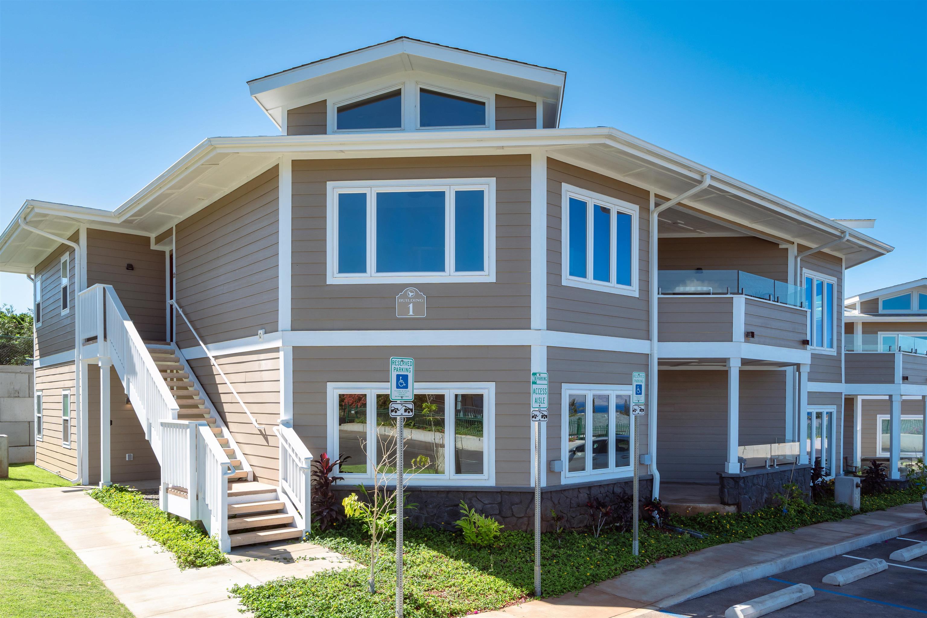 2757 South Kihei Road, Unit 101 Kihei, HI 96753 - Photo 17 of 26 a front view of a house with a yard