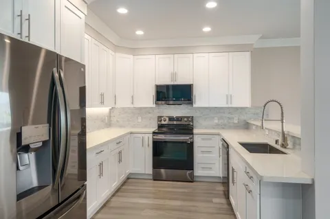 a kitchen with a sink stove and refrigerator