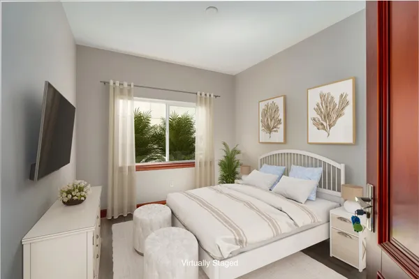 a bedroom with a bed and a flat screen tv