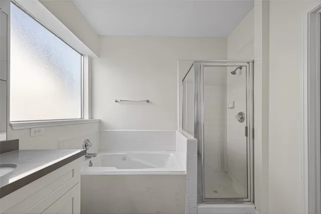 a bathroom with a tub a sink and mirror