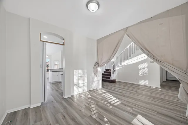 a view of entryway and hall with wooden floor