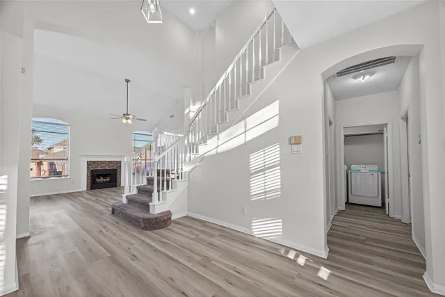 a view of entryway and hall with wooden floor