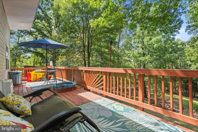a view of a chairs and table on the wooden deck