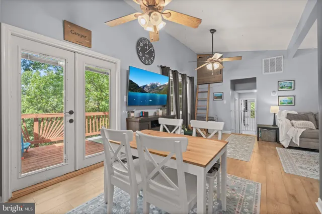 a view of a dining room with furniture wooden floor and chandelier