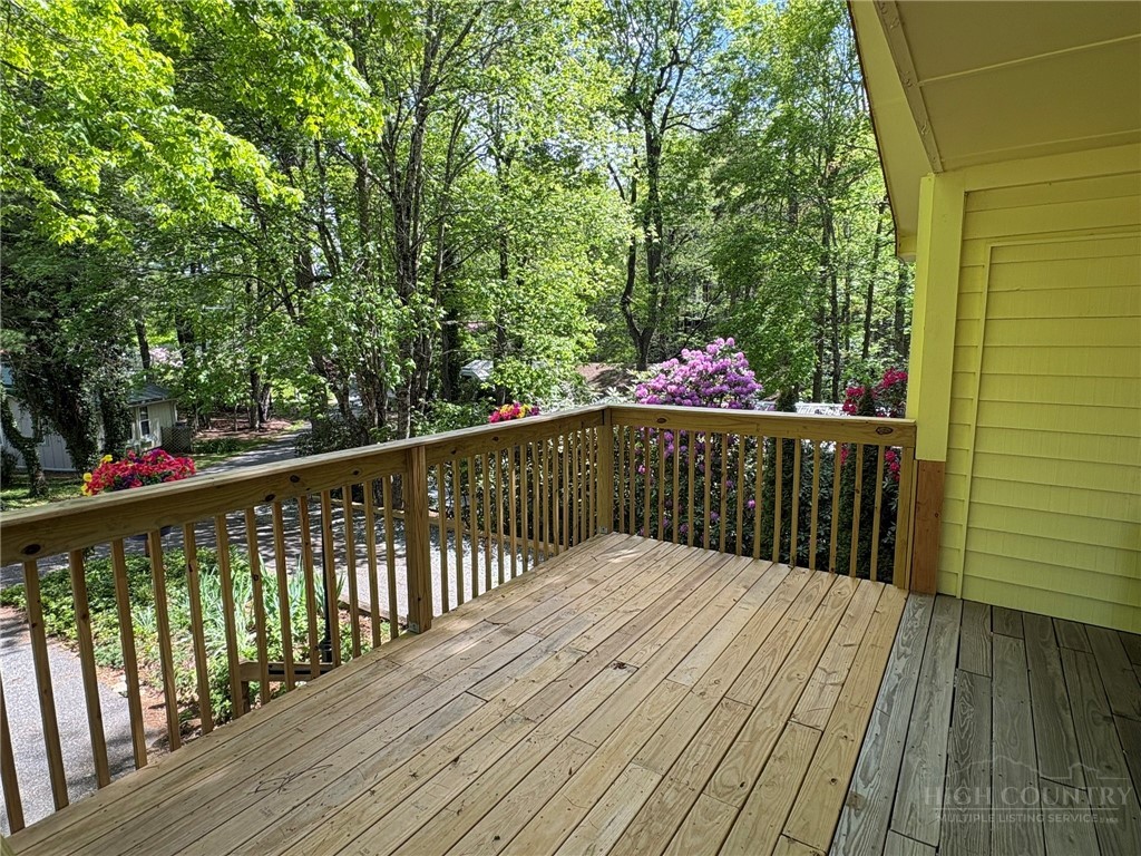 6 Ridgewood Lane Newland, NC 28657 - Photo 3 of 45 a balcony with wooden floor and trees in the back