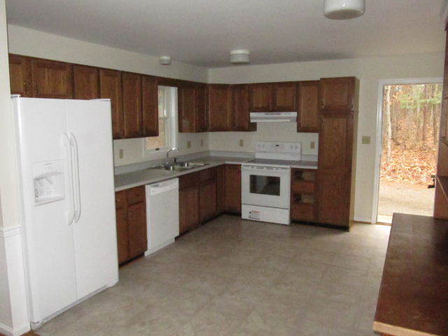 1812 King Richard Road Ferrum, VA 24088 - Photo 3 of 12 a kitchen with stainless steel appliances granite countertop a stove a refrigerator and a sink