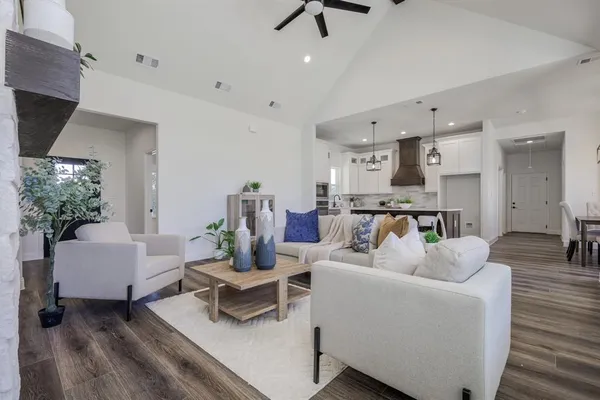 a living room with furniture and a wooden floor
