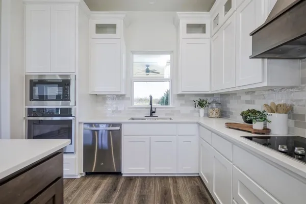a kitchen with a sink stove and cabinets