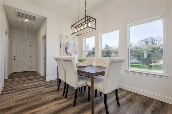 a view of a dining room with furniture window and wooden floor