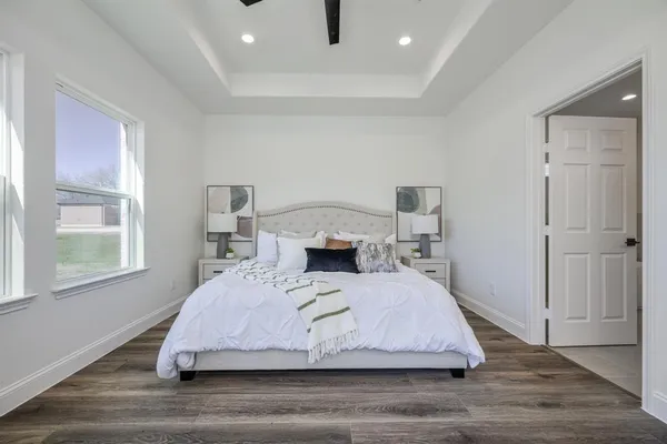a bedroom with a bed and wooden floor