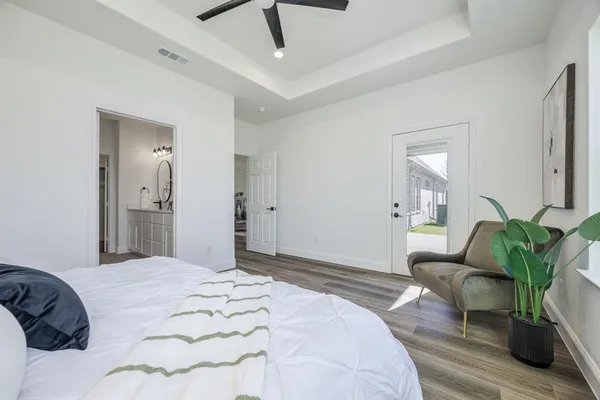 a bedroom with a bed and wooden floor