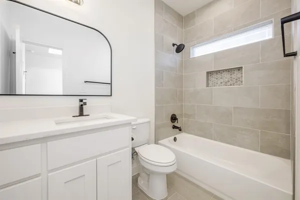 a bathroom with a sink a toilet and bathtub