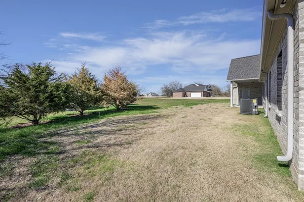 a view of a house with a yard and garage