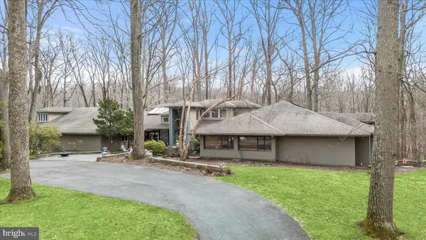 a view of a house with backyard sitting area and porch