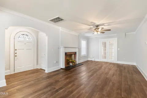 a living room with furniture a rug and a window