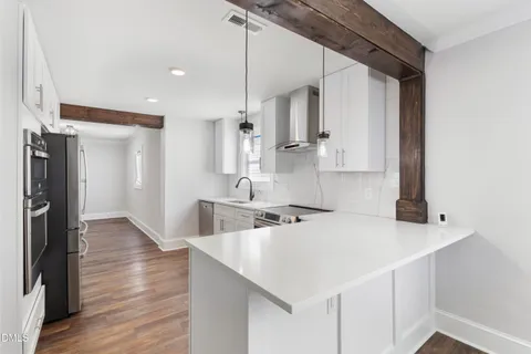 a view of an empty room and wooden floor