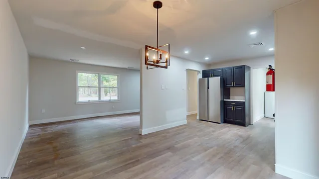 a view of a room with refrigerator and windows