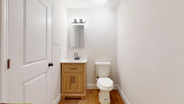 a white toilet sitting next to a bathroom sink