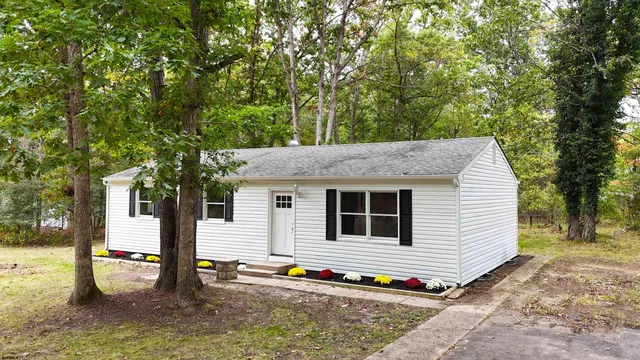 a backyard of a house with barbeque oven table and chairs