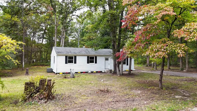 a view of a house with a tree in front