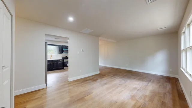 a view of a room window and wooden floor