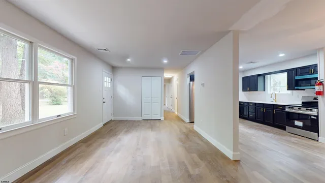 a view of a kitchen with a sink and a window