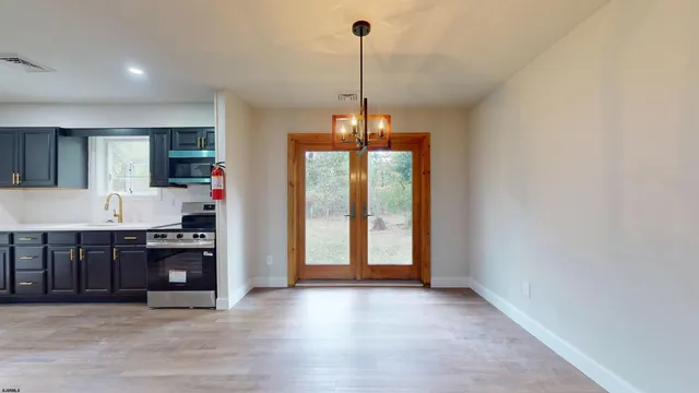 a kitchen with kitchen island a counter top space appliances and cabinets