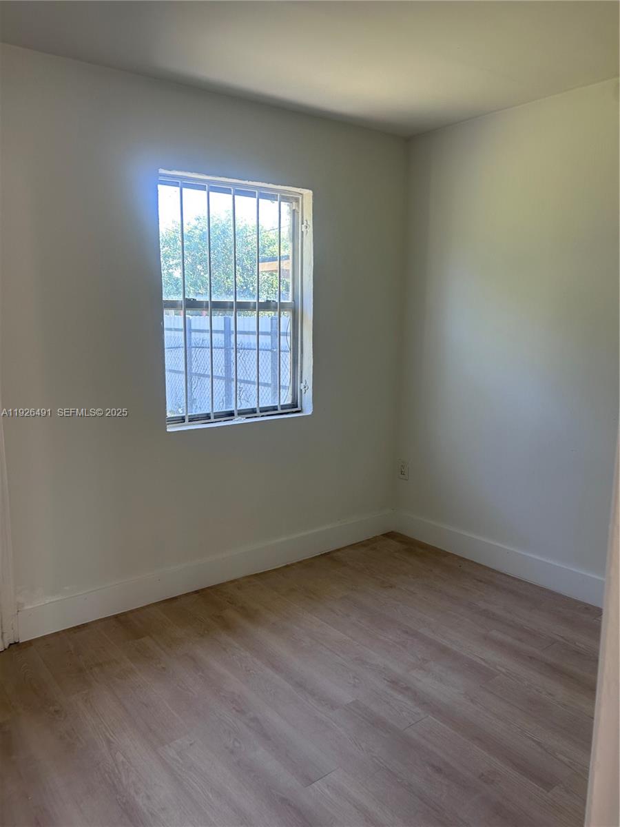 1820 Northwest 73rd Street, Unit 1820 Miami, FL 33147 - Photo 4 of 7 an empty room with a window