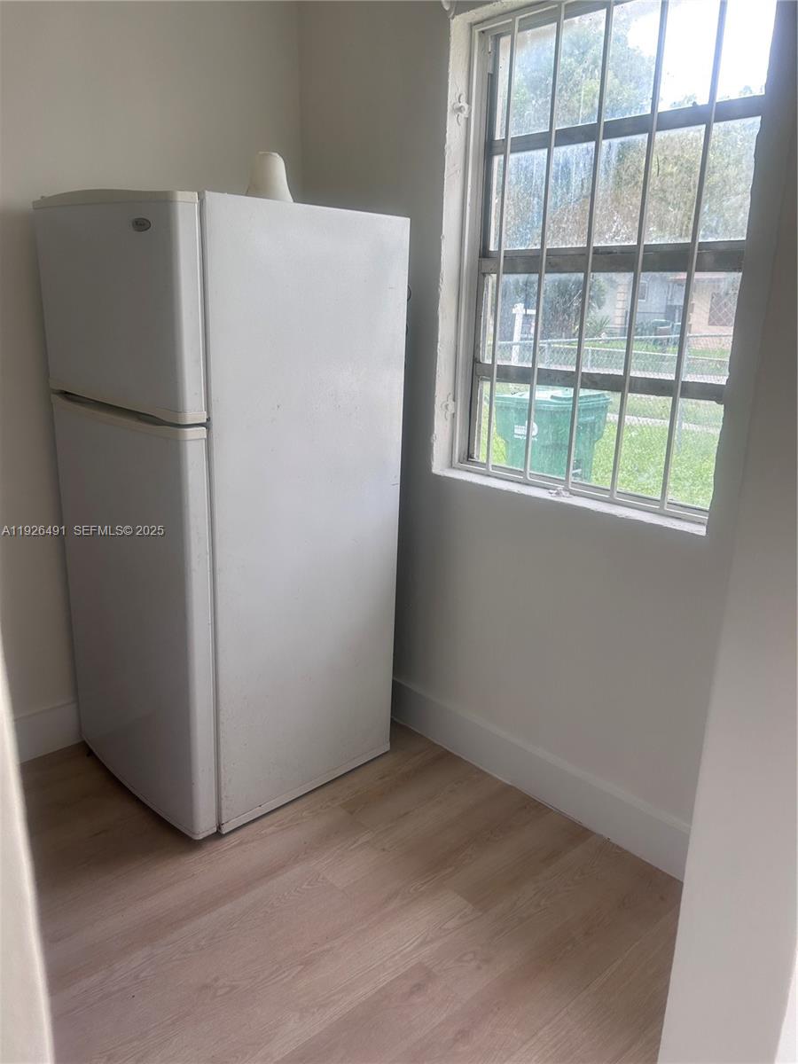 1820 Northwest 73rd Street, Unit 1820 Miami, FL 33147 - Photo 6 of 7 a view of a refrigerator in kitchen and a refrigerator in kitchen