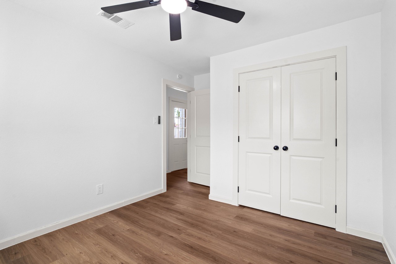 5326 Findlay Drive Pasadena, TX 77505 - Photo 42 of 50 Bright secondary bedroom featuring a ceiling fan, double-door closet, and durable luxury vinyl plank flooring.