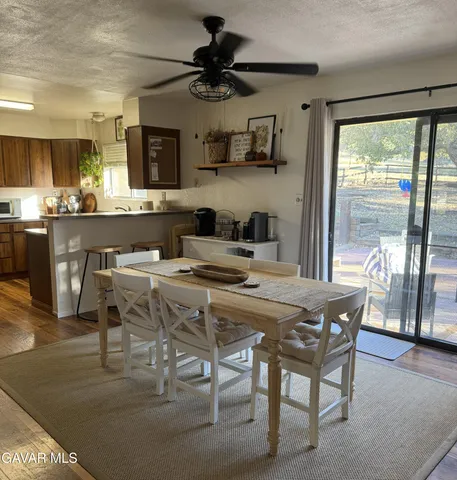a kitchen with stainless steel appliances granite countertop table chairs sink and stove