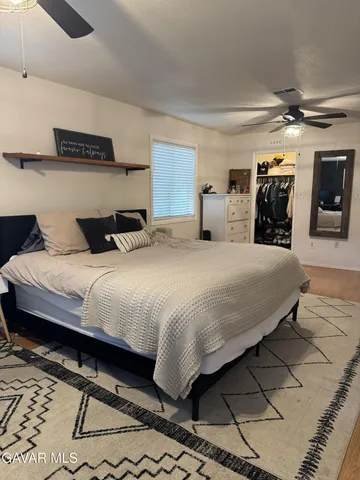 a bedroom with double bed and a mirror