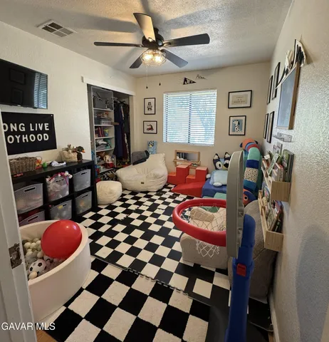 a bedroom with furniture and a flat screen tv