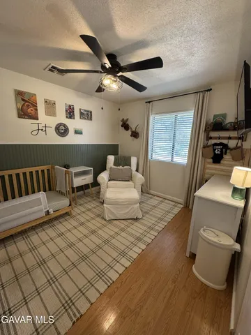 a bedroom with furniture and wooden floor