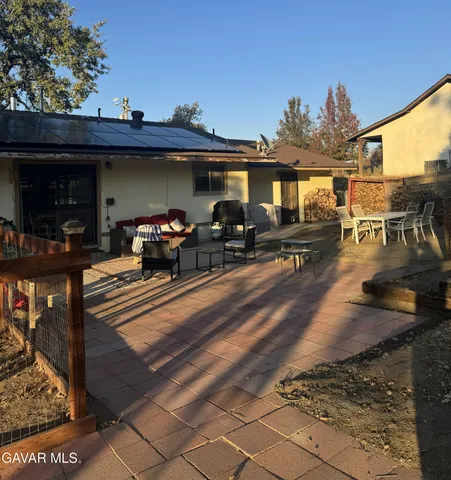 a view of a porch with furniture and floor to ceiling window