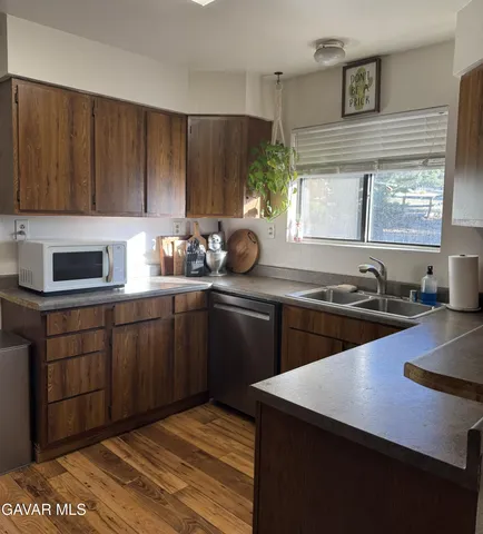 a kitchen with sink cabinets and window