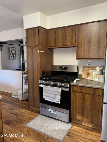 a kitchen with stainless steel appliances wooden cabinets sink and stove