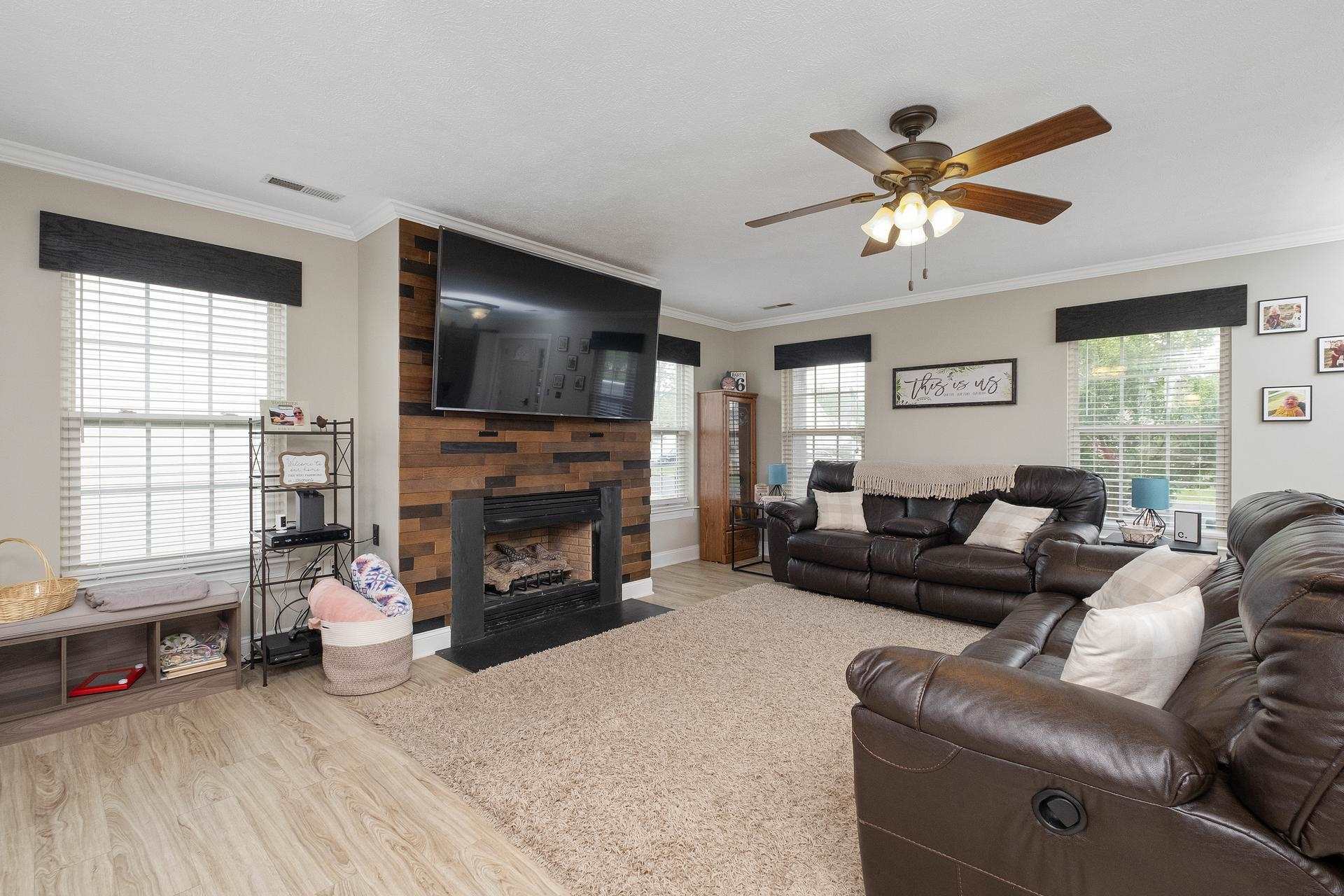 2425 Monroe Street Waynesboro, VA 22980 - Photo 9 of 42 a living room with furniture a fireplace and a flat screen tv