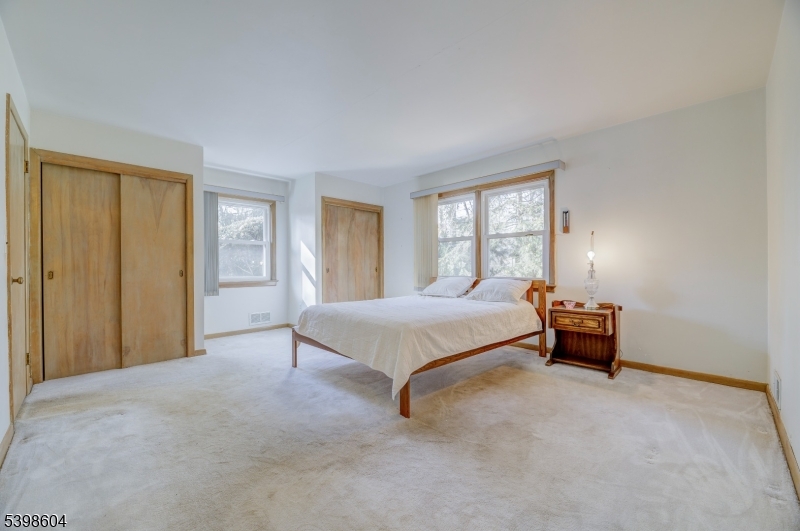 1621 Terrill Road Scotch Plains, NJ 07076 - Photo 21 of 48 a spacious bedroom with a bed and a window