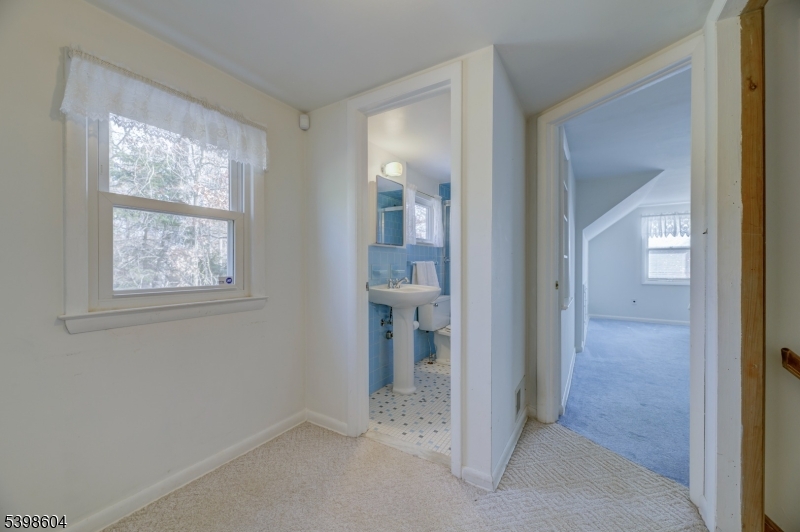 1621 Terrill Road Scotch Plains, NJ 07076 - Photo 24 of 48 an empty room and a bathroom with mirror