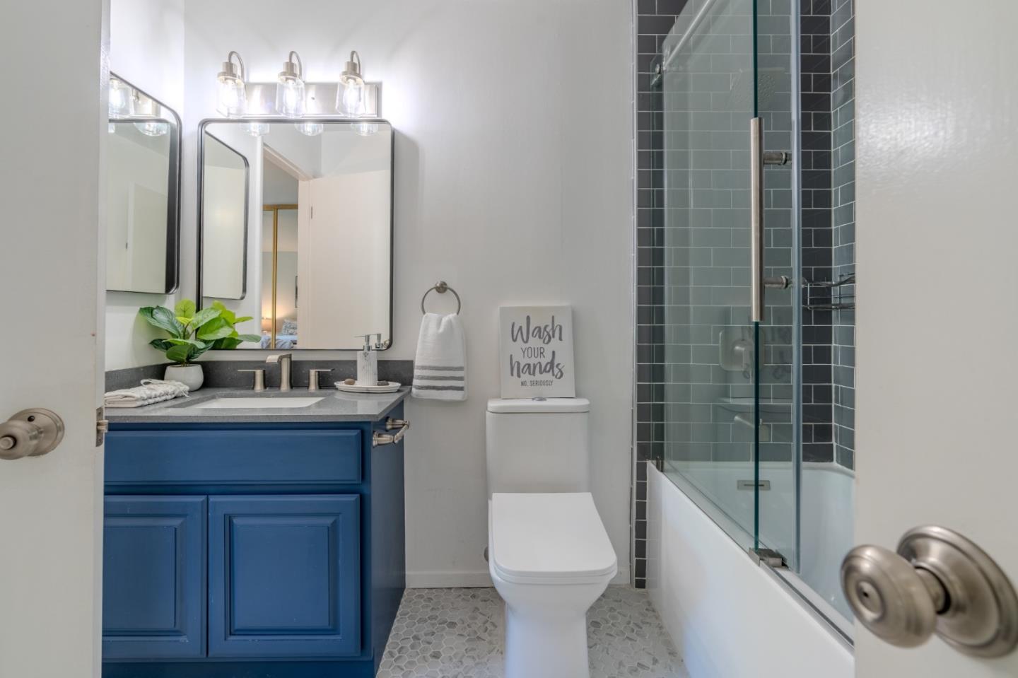 1039 Oddstad Boulevard Pacifica, CA 94044 - Photo 28 of 35 a bathroom with a granite countertop sink a toilet a mirror and shower