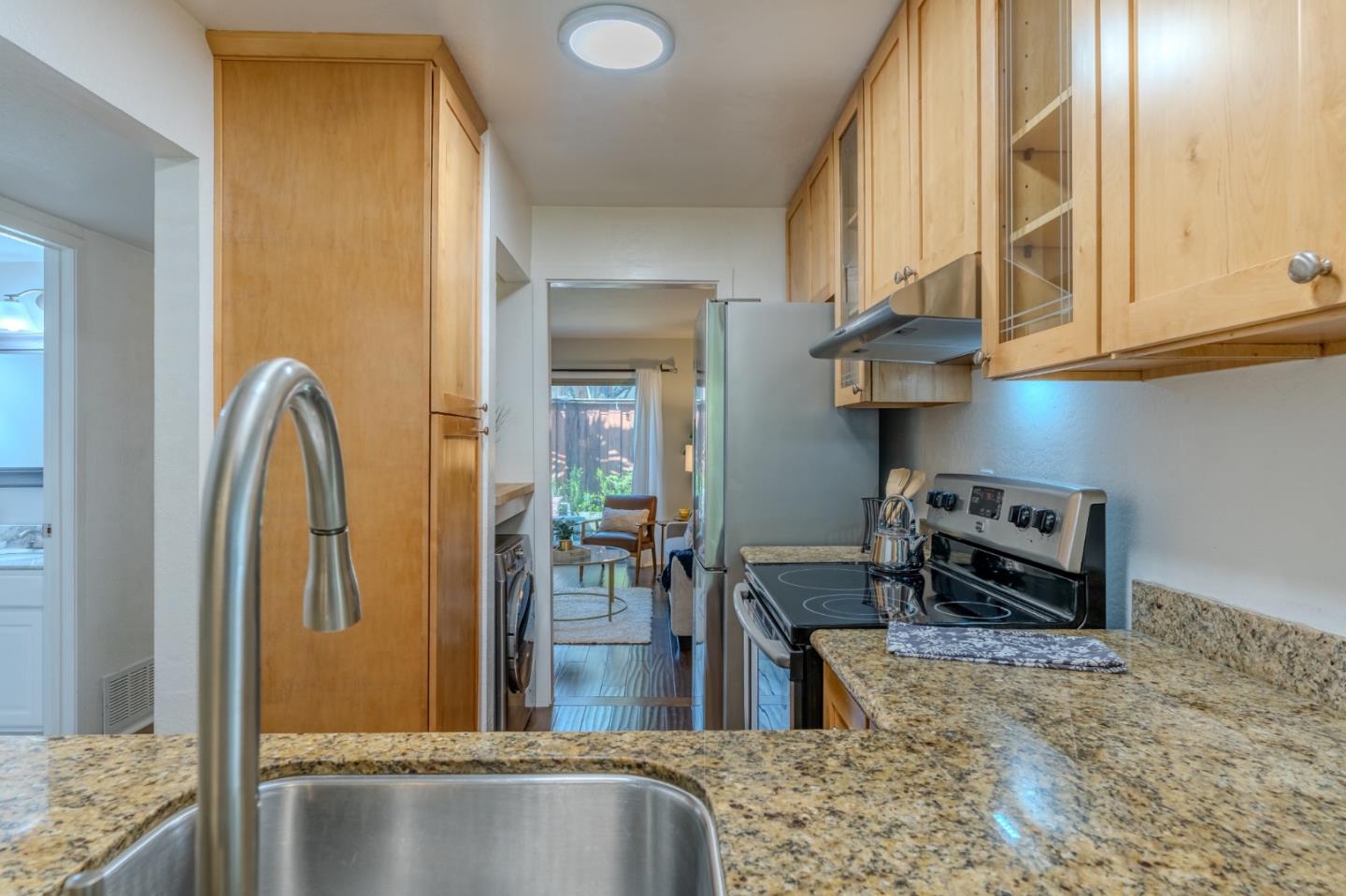 1039 Oddstad Boulevard Pacifica, CA 94044 - Photo 7 of 35 a kitchen with stainless steel appliances granite countertop a refrigerator and a stove
