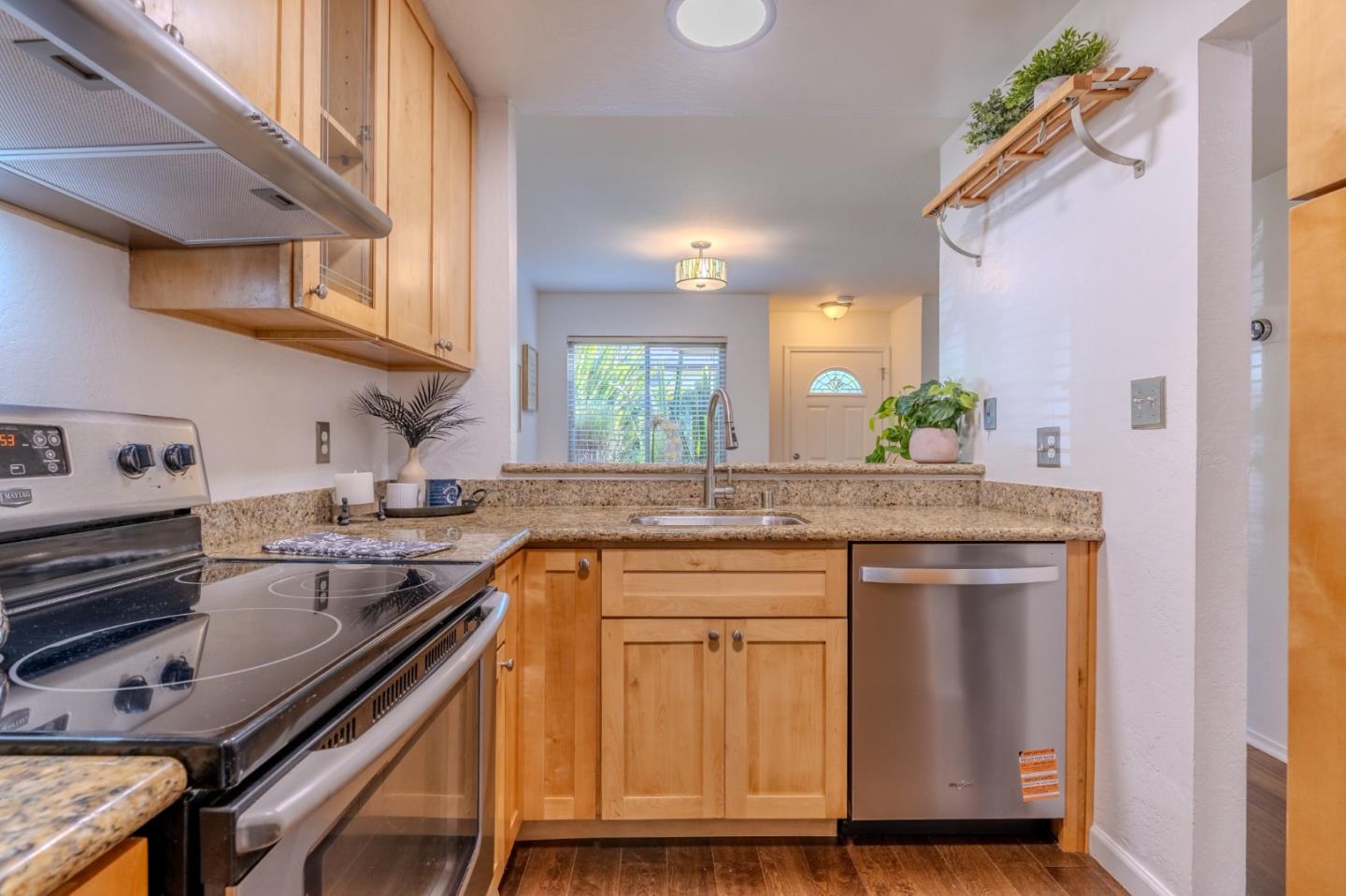 1039 Oddstad Boulevard Pacifica, CA 94044 - Photo 9 of 35 a kitchen with kitchen island granite countertop a sink stove and cabinets