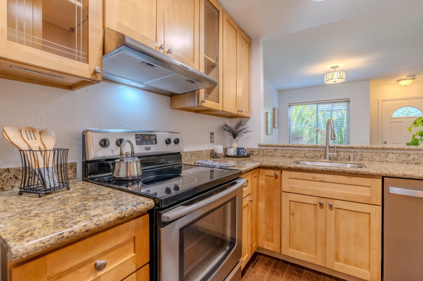 1039 Oddstad Boulevard Pacifica, CA 94044 - Photo 10 of 35 a kitchen with stainless steel appliances granite countertop a sink stove and cabinets